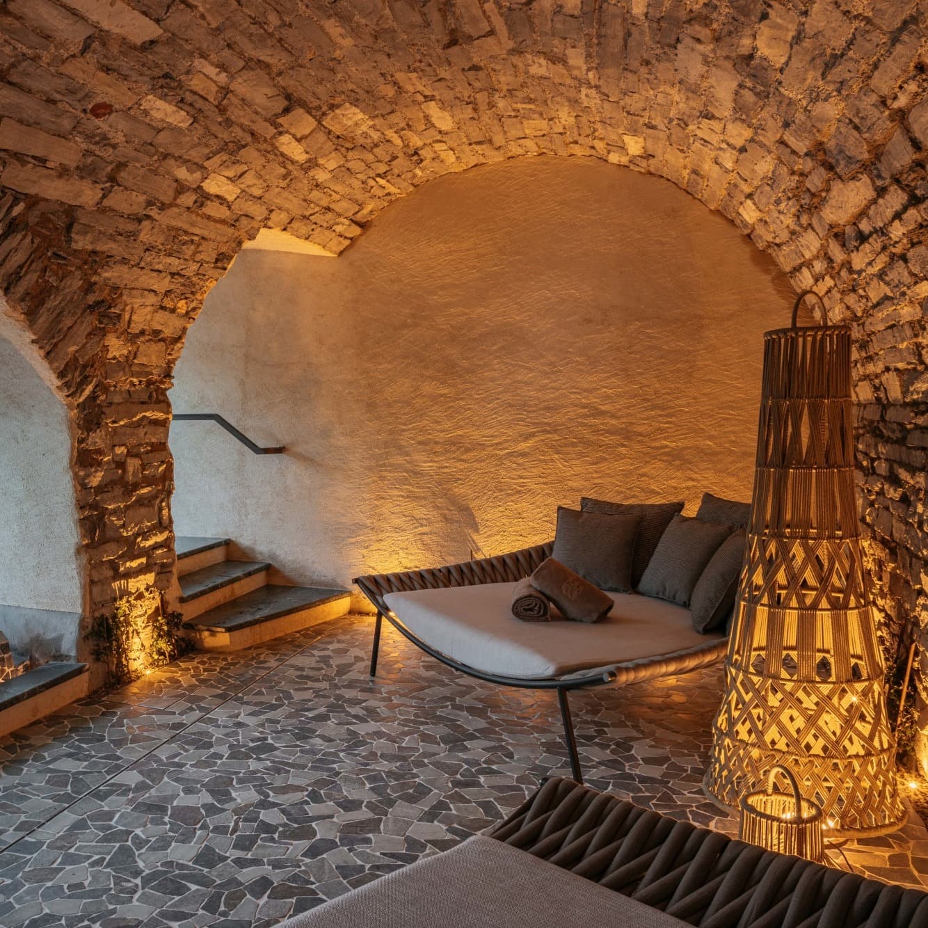 a relaxation area with a small pool and stone vaulted ceilings