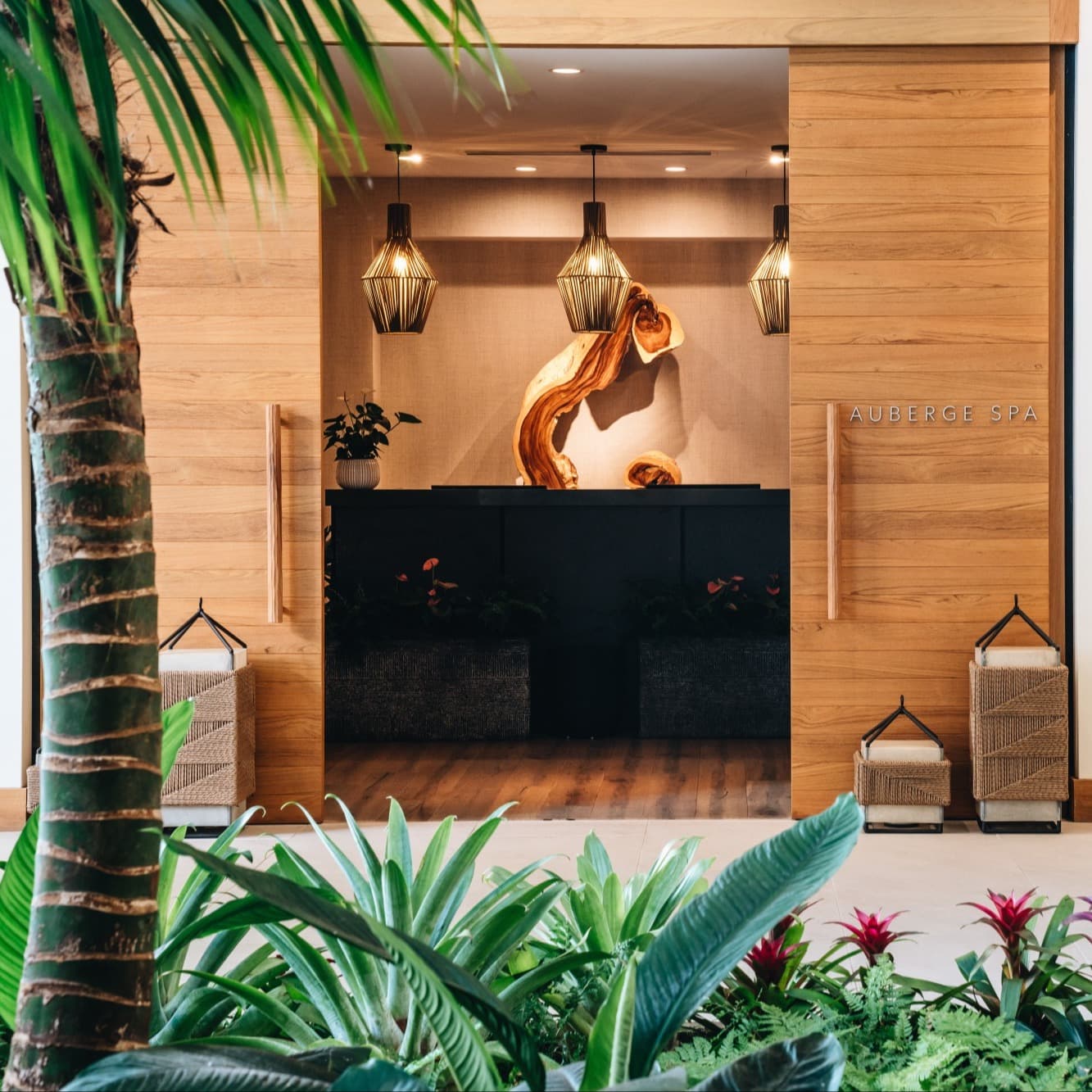 a spa entry area with a black desk behind pale wooden sliding doors