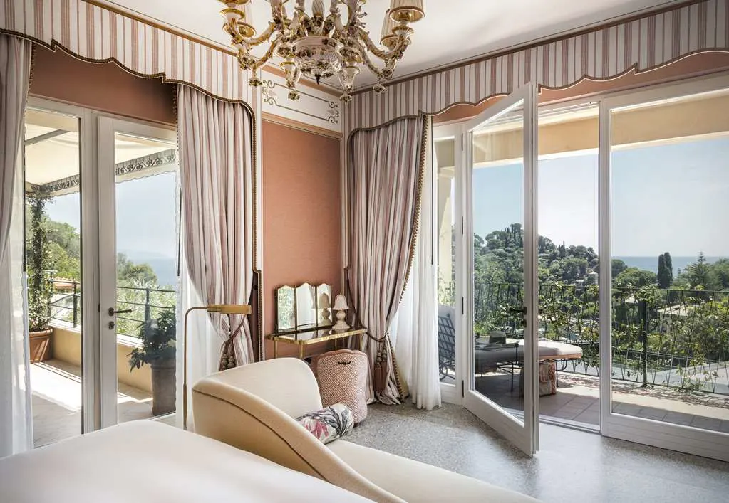 a light-filled bedroom overlooking a lush valley