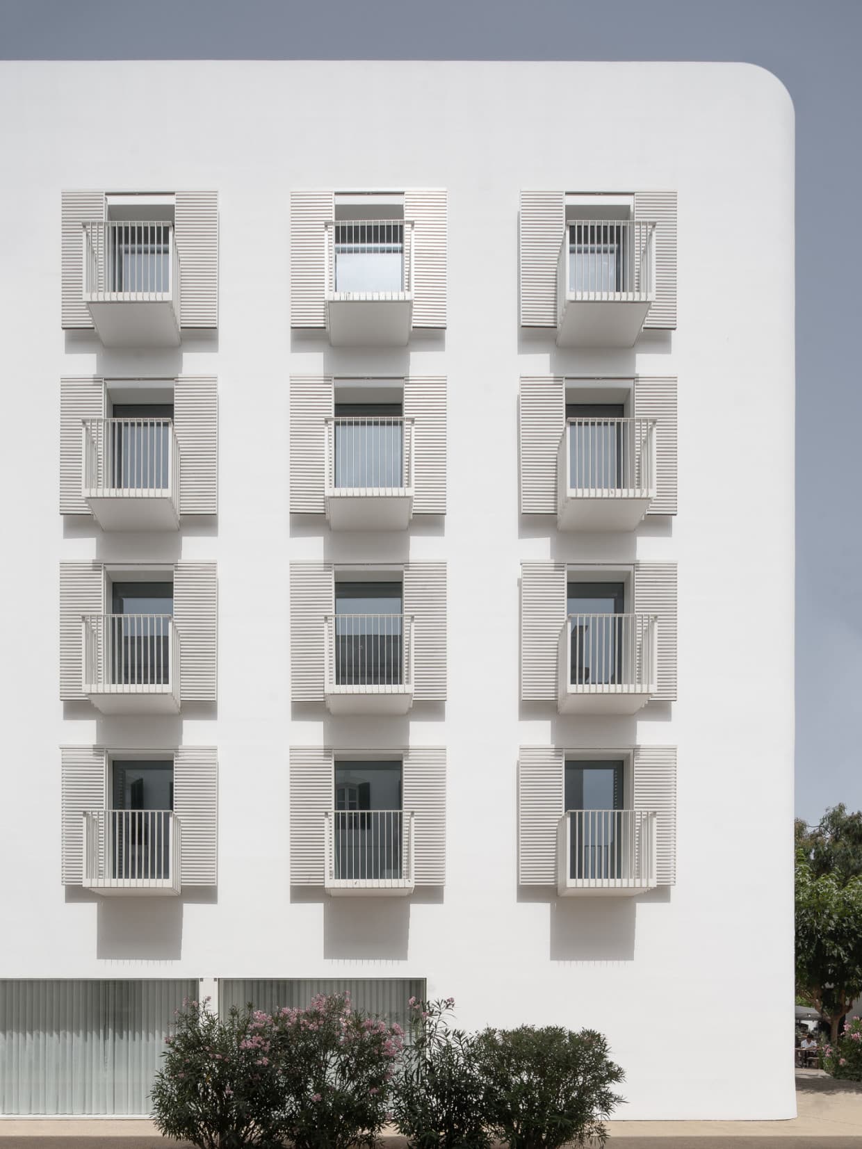 white exterior of a building with white shutters