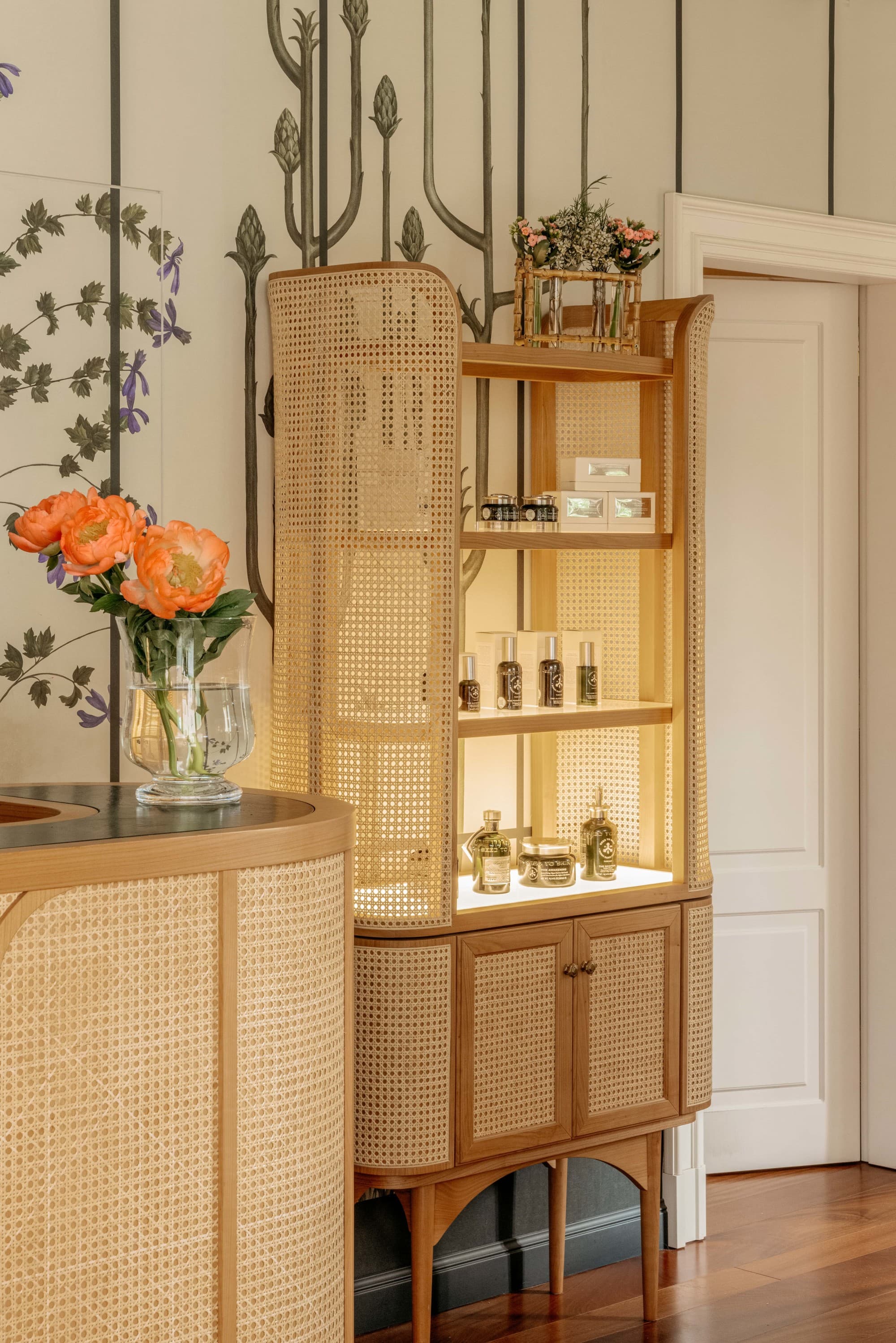 a wicker armoir filled with skincare products