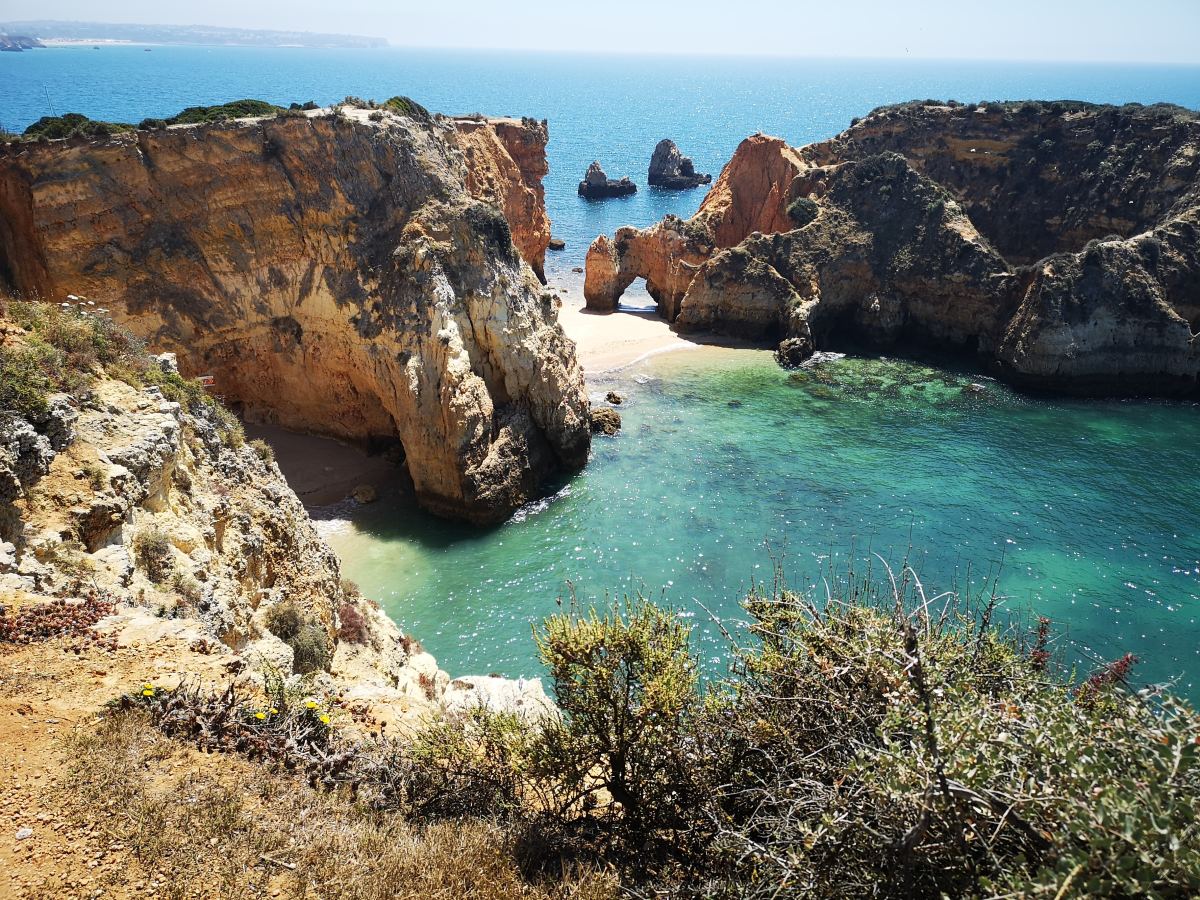 Rock formations near the shoreline during daytime.