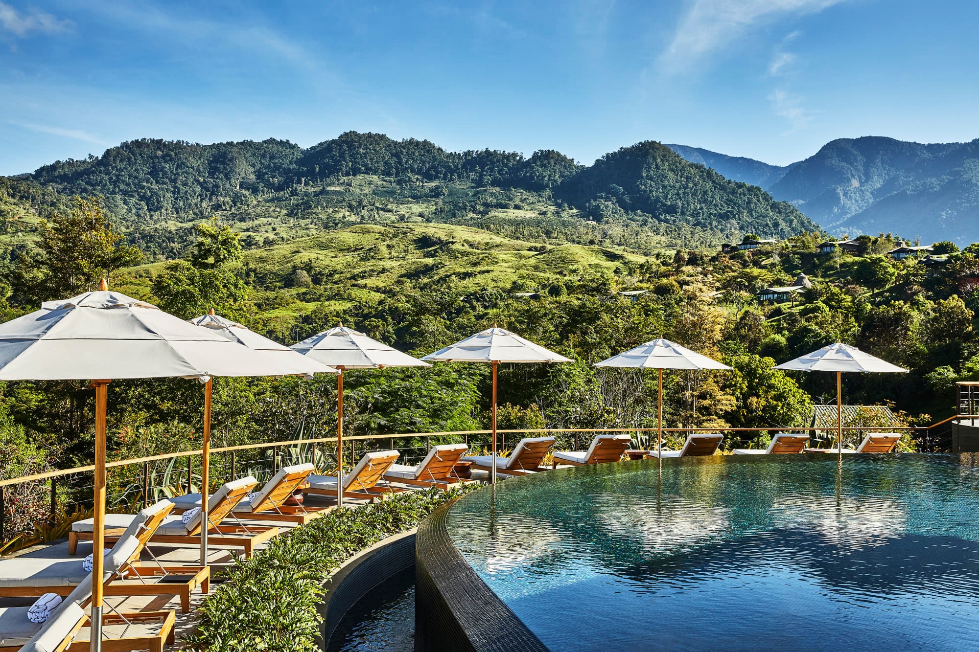 an infinity-edged pool overlooking a jungly mountain