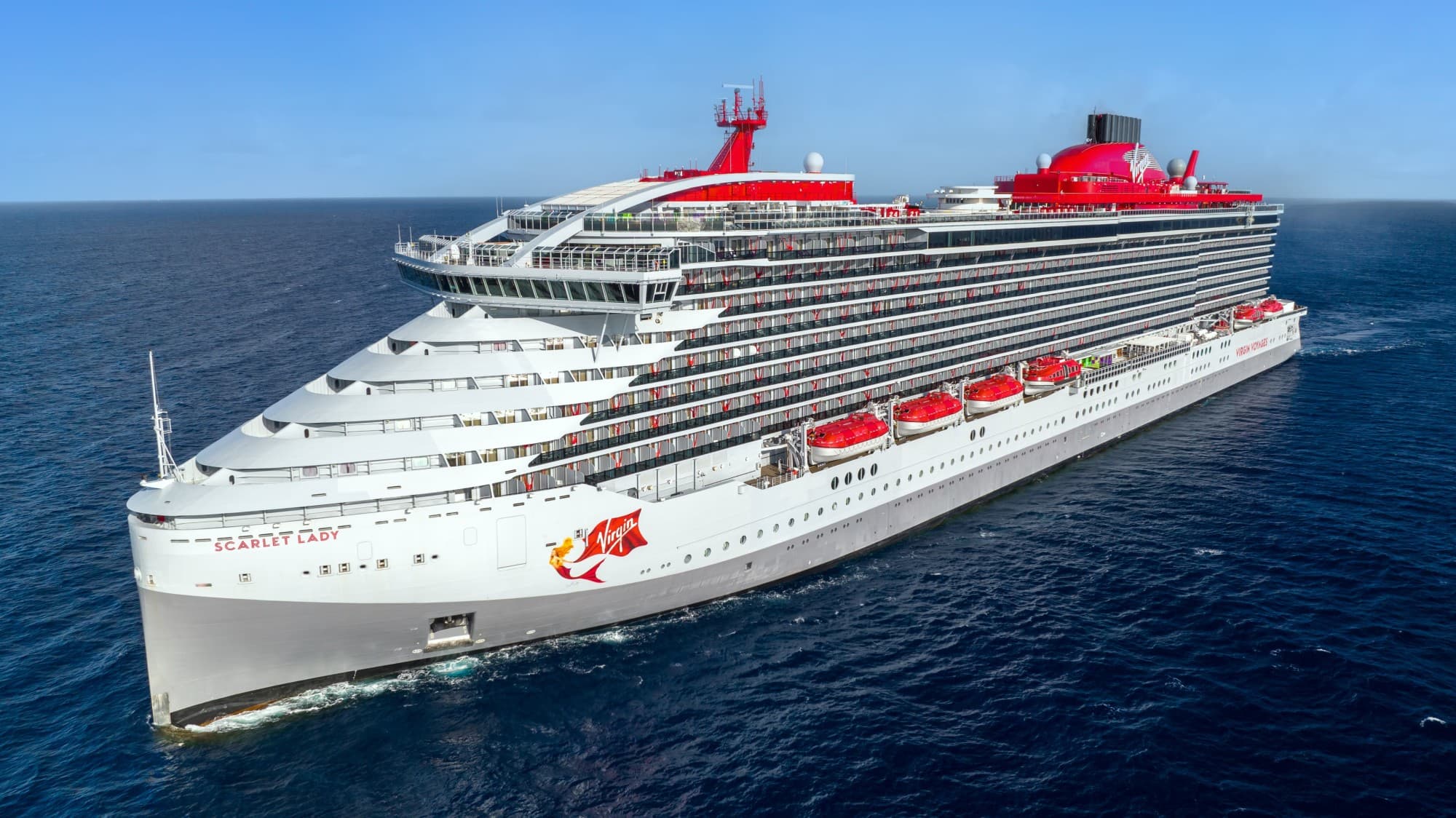 Virgin Voyages Cruise Ship on the water on a sunny day.